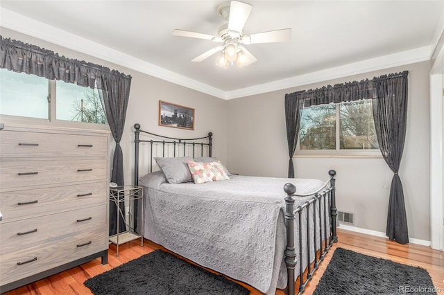 6905 Nelson St, Arvada, CO 80004 - bedroom featuring a ceiling fan, visible vents, multiple windows, and light wood-style flooring