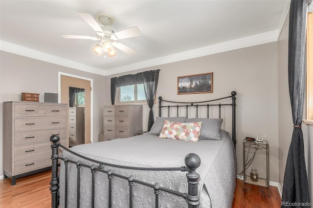 6905 Nelson St, Arvada, CO 80004 - bedroom with crown molding, baseboards, a ceiling fan, and light wood finished floors