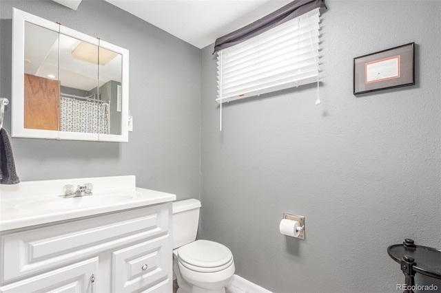 6905 Nelson St, Arvada, CO 80004 - full bathroom with toilet, a shower with curtain, and vanity