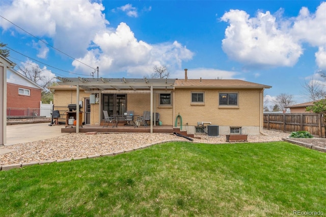 6905 Nelson St, Arvada, CO 80004 - back of property featuring a yard, brick siding, a patio, and a fenced backyard