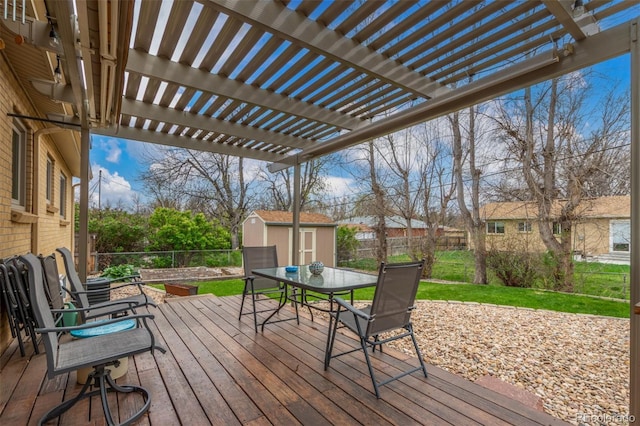 6905 Nelson St, Arvada, CO 80004 - wooden deck featuring a pergola, a storage shed, a fenced backyard, an outbuilding, and outdoor dining area