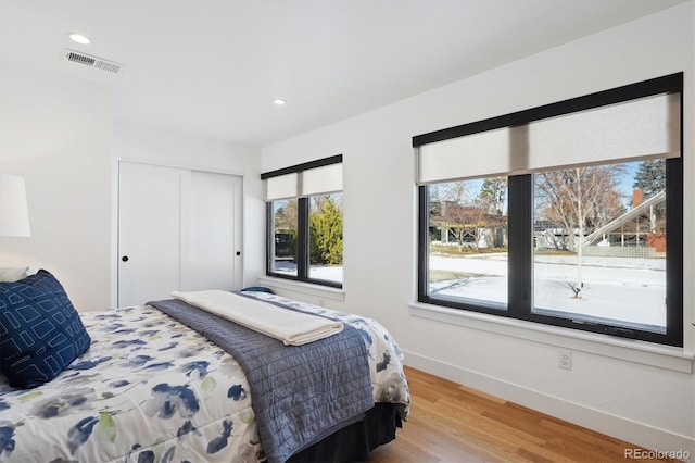 bedroom featuring a closet and light hardwood / wood-style flooring