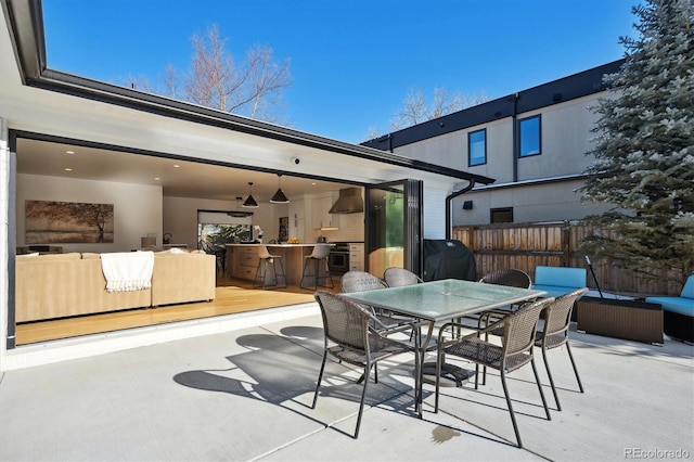 view of patio / terrace with grilling area, an outdoor hangout area, and an outdoor bar