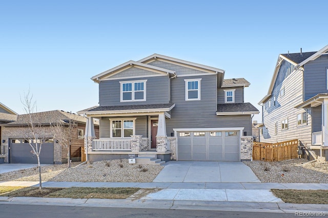 craftsman inspired home with a porch, an attached garage, driveway, and fence