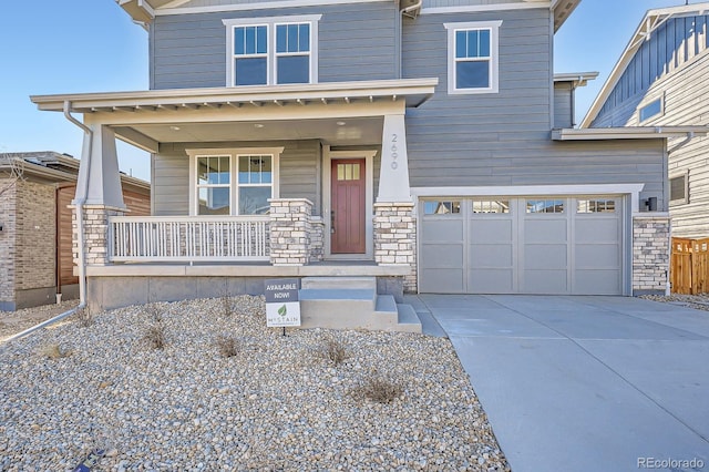 craftsman house featuring stone siding, an attached garage, a porch, and driveway