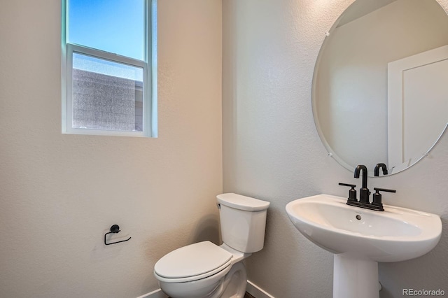 bathroom featuring toilet and a sink