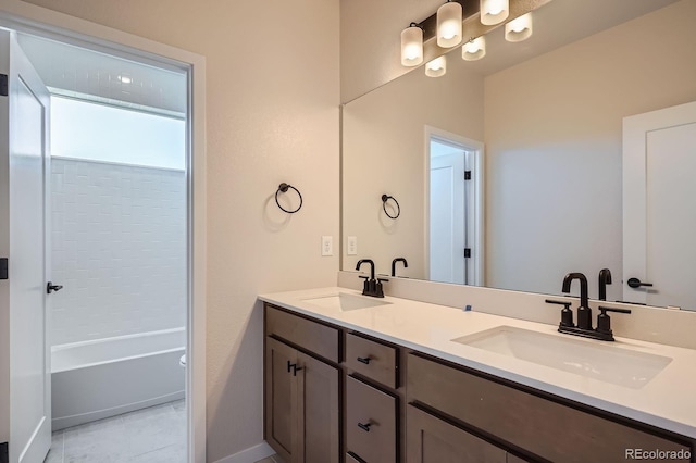 bathroom featuring double vanity, tile patterned flooring, baseboards, and a sink