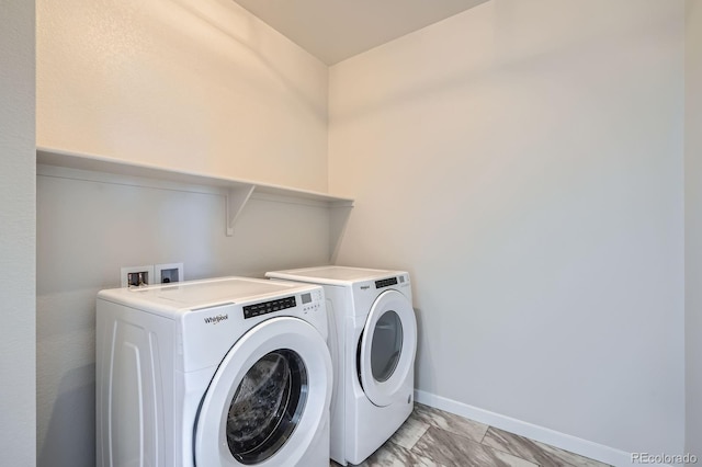 laundry area with laundry area, independent washer and dryer, marble finish floor, and baseboards