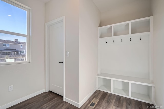 mudroom featuring visible vents, baseboards, and dark wood-style floors