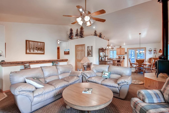 living room with lofted ceiling, ceiling fan, and light carpet