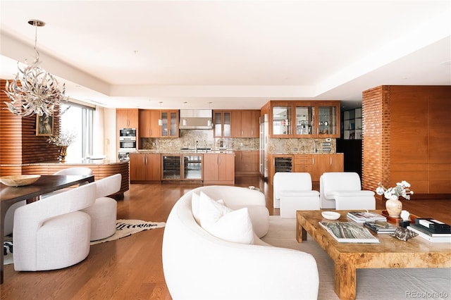 1133 14th St Unit 3420, Denver, CO 80202 - living area with wine cooler, wood finished floors, a tray ceiling, and a chandelier