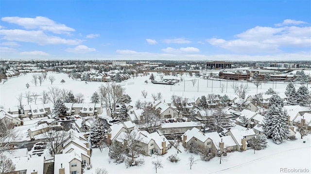 snowy aerial view featuring a residential view