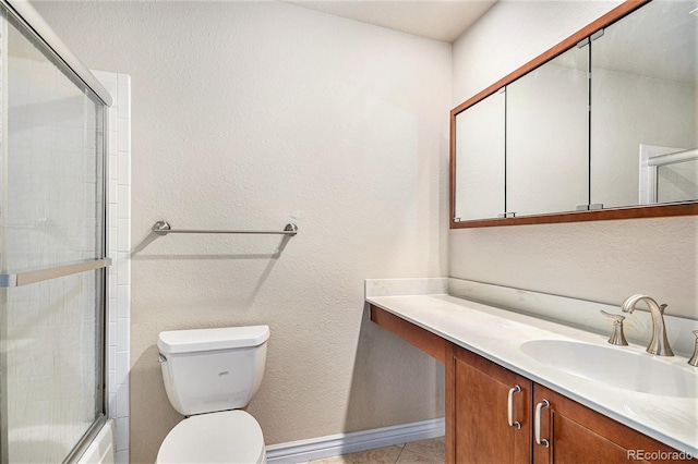 bathroom with enclosed tub / shower combo, tile patterned flooring, toilet, vanity, and baseboards