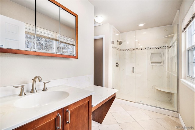 full bath with tile patterned floors, a shower stall, and vanity