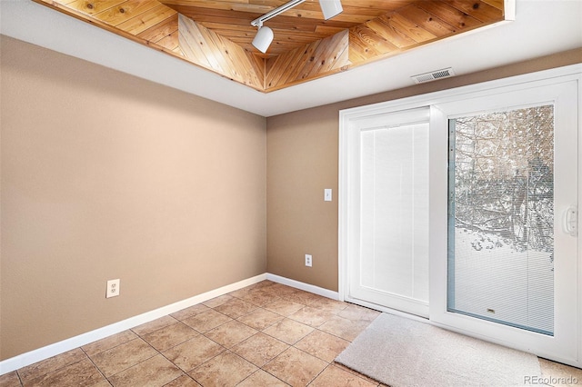 spare room featuring wood ceiling, baseboards, visible vents, a raised ceiling, and track lighting