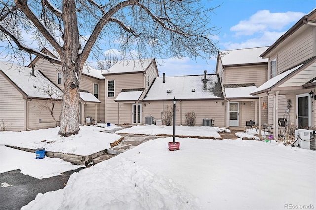 yard layered in snow featuring central AC unit