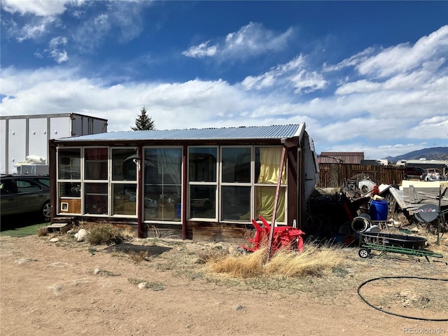 11469 Ruby Mountain Ln, Nathrop, CO 81236 - back of house featuring a sunroom and a metal roof