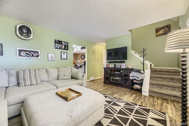 14742 E Radcliff Pl, Aurora, CO 80015 - living area featuring stairs, wood finished floors, and a textured ceiling