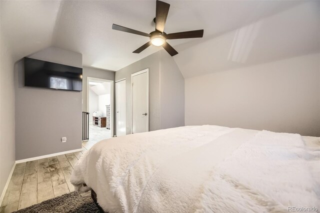 14742 E Radcliff Pl, Aurora, CO 80015 - bedroom featuring wood finished floors, baseboards, lofted ceiling, and a ceiling fan