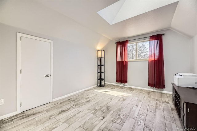 14742 E Radcliff Pl, Aurora, CO 80015 - additional living space with lofted ceiling, wood finished floors, a skylight, and baseboards