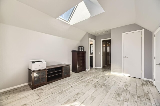 14742 E Radcliff Pl, Aurora, CO 80015 - additional living space with light wood finished floors, lofted ceiling, baseboards, and a skylight