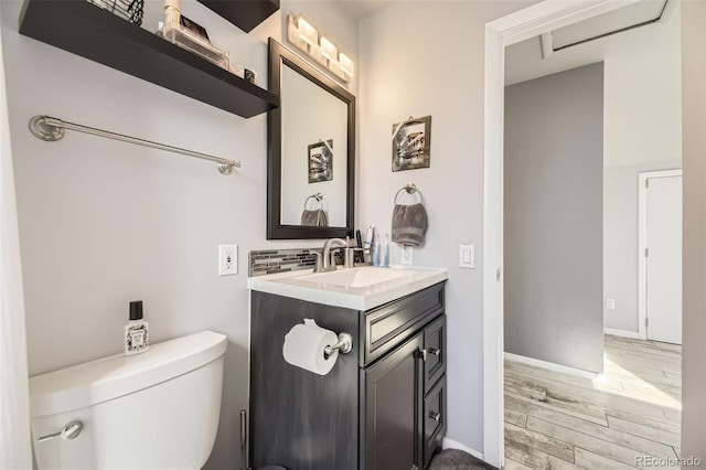 14742 E Radcliff Pl, Aurora, CO 80015 - bathroom featuring wood finished floors, toilet, vanity, and baseboards