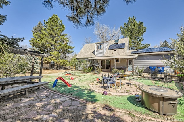 14742 E Radcliff Pl, Aurora, CO 80015 - back of property featuring solar panels, a patio area, a pergola, roof with shingles, and fence