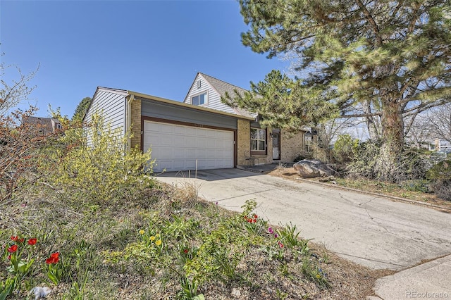 14742 E Radcliff Pl, Aurora, CO 80015 - view of front of property featuring an attached garage, driveway, and brick siding