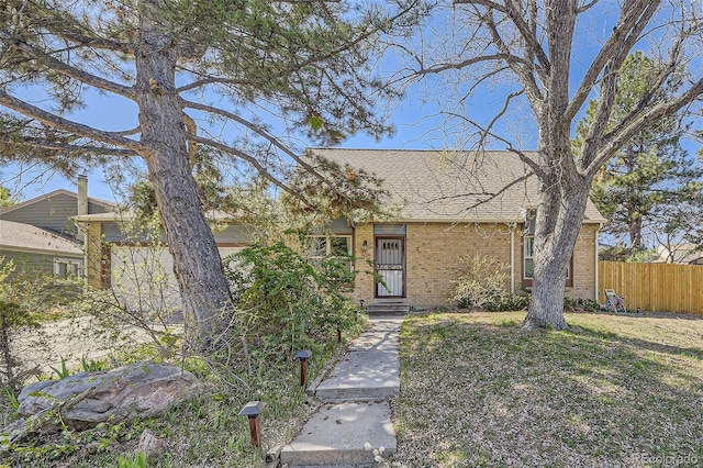 14742 E Radcliff Pl, Aurora, CO 80015 - view of front of property featuring fence, brick siding, and roof with shingles