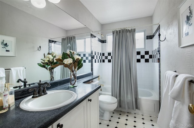 full bathroom featuring toilet, shower / tub combo, a wealth of natural light, and vanity