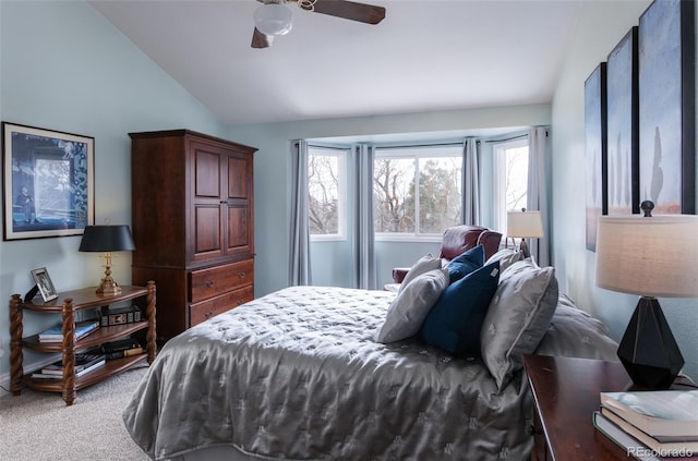 bedroom featuring vaulted ceiling, light colored carpet, and ceiling fan