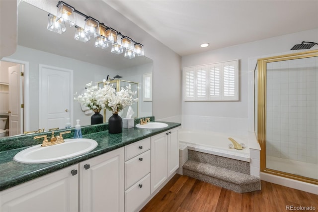 bathroom featuring vanity, hardwood / wood-style floors, and independent shower and bath