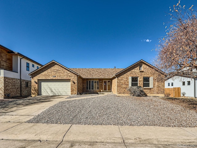 single story home with an attached garage, driveway, fence, and brick siding