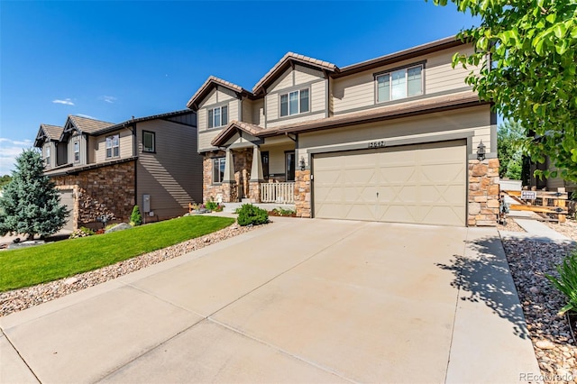 15647 Weaver Gulch Dr, Morrison, CO 80465 - craftsman-style house with stone siding, an attached garage, driveway, and a front lawn