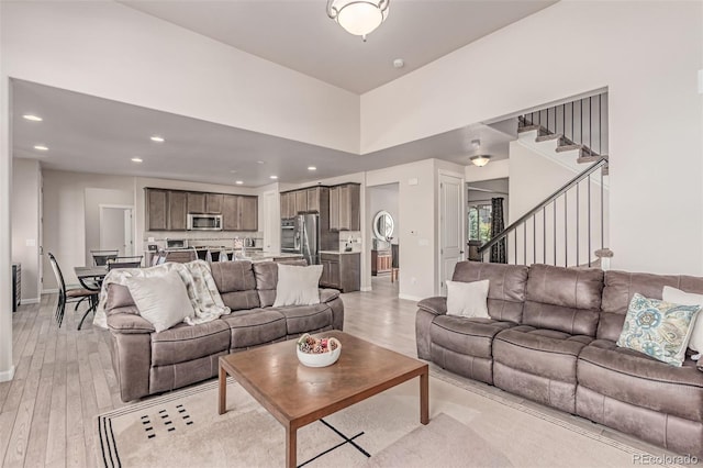 15647 Weaver Gulch Dr, Morrison, CO 80465 - living room with light wood-style floors, stairs, and recessed lighting