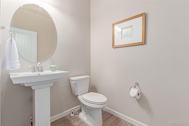 15647 Weaver Gulch Dr, Morrison, CO 80465 - half bath with wood finished floors and toilet