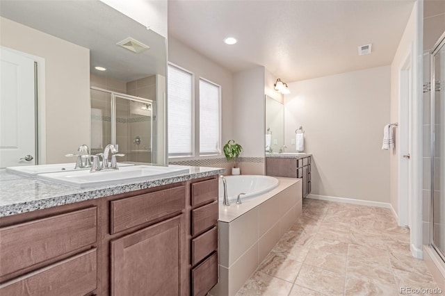 15647 Weaver Gulch Dr, Morrison, CO 80465 - bathroom featuring a stall shower, two vanities, a garden tub, and recessed lighting