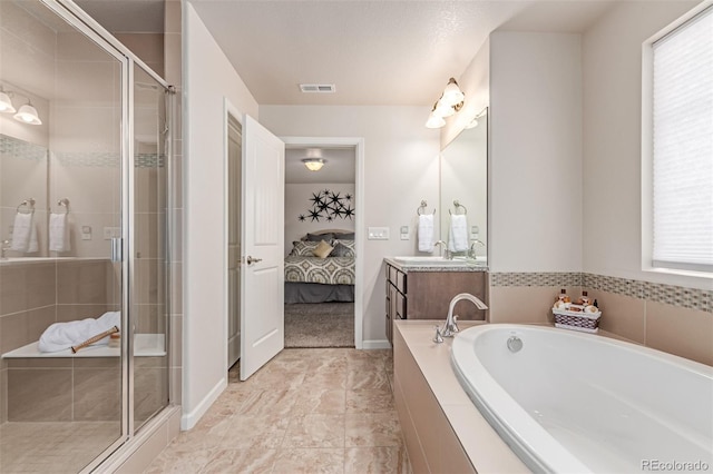 15647 Weaver Gulch Dr, Morrison, CO 80465 - ensuite bathroom featuring vanity, a bath, and a stall shower
