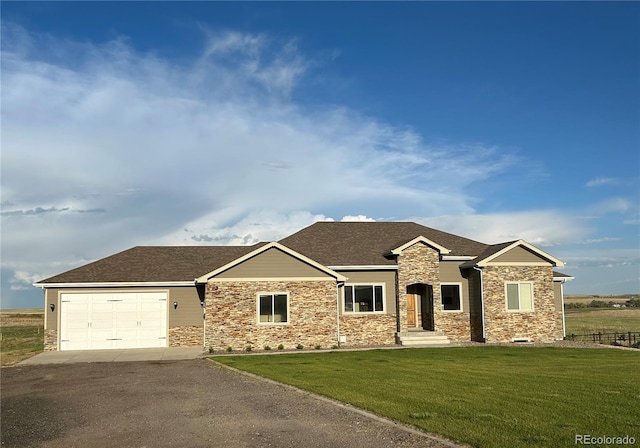 view of front of home with a garage and a front yard