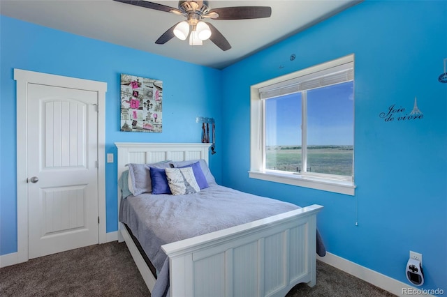 bedroom featuring ceiling fan and dark carpet