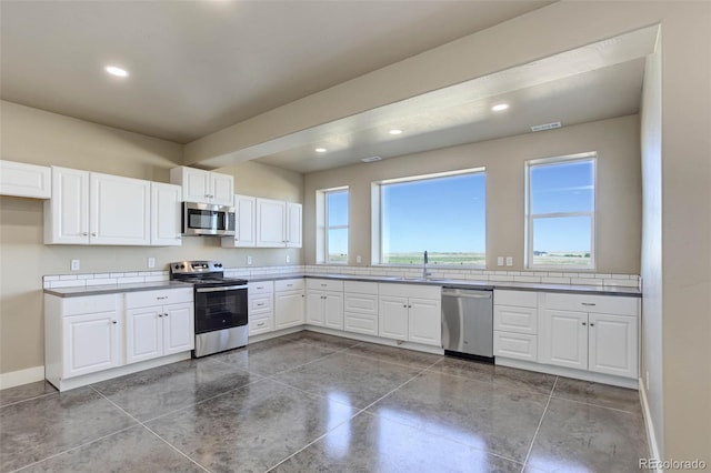 kitchen featuring white cabinetry, appliances with stainless steel finishes, and sink