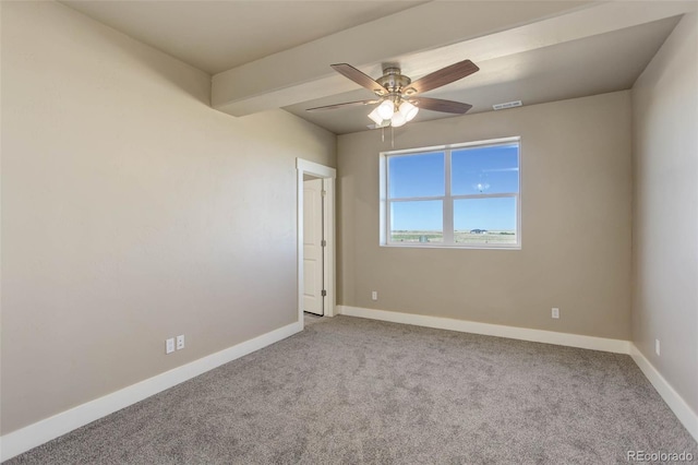 spare room with beamed ceiling, ceiling fan, and carpet floors