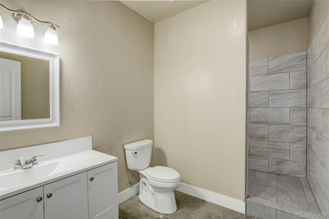 bathroom featuring vanity, toilet, and tile patterned flooring