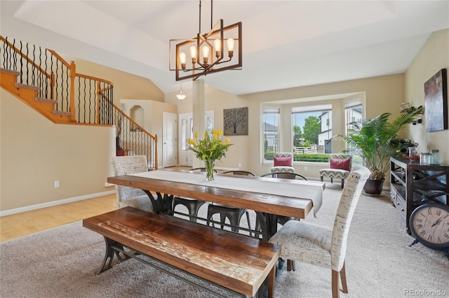 9158 Forest St, Firestone, CO 80504 - dining space featuring stairs, baseboards, a chandelier, vaulted ceiling, and wood finished floors