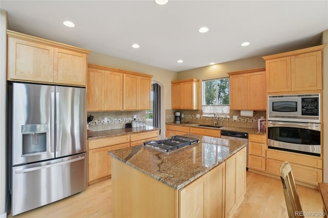 9158 Forest St, Firestone, CO 80504 - kitchen featuring appliances with stainless steel finishes, light brown cabinets, a sink, light wood-style floors, and recessed lighting