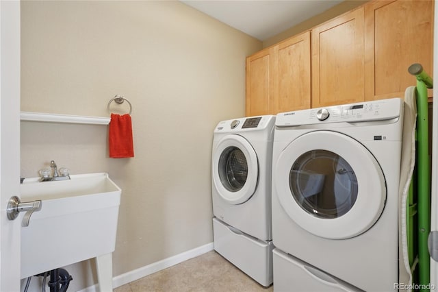 9158 Forest St, Firestone, CO 80504 - laundry area with washing machine and clothes dryer, baseboards, and cabinet space