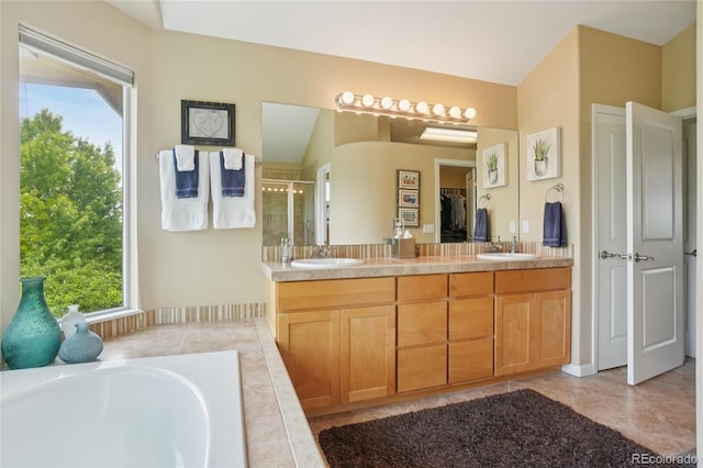 9158 Forest St, Firestone, CO 80504 - bathroom with a shower stall, double vanity, a garden tub, vaulted ceiling, and tile patterned flooring