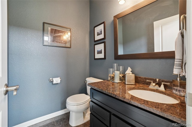 9158 Forest St, Firestone, CO 80504 - half bathroom with toilet, vanity, baseboards, tile patterned flooring, and a textured wall