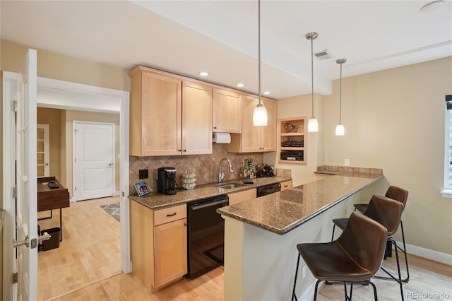9158 Forest St, Firestone, CO 80504 - kitchen featuring black dishwasher, light brown cabinets, tasteful backsplash, a sink, and a peninsula