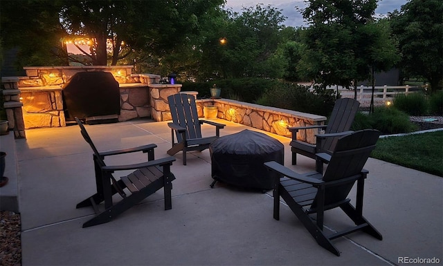 9158 Forest St, Firestone, CO 80504 - patio terrace at dusk with an outdoor fire pit, a patio area, and area for grilling